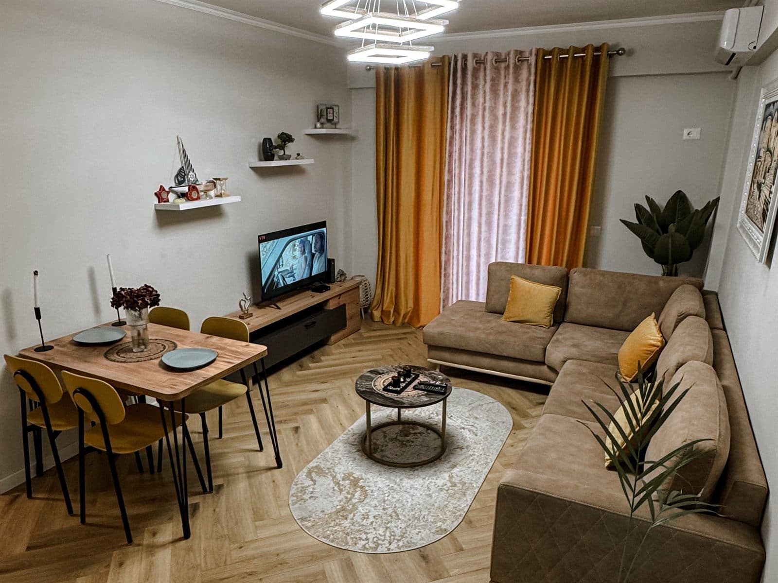 Autokton City Apartment Tirana living area with sofa and dining table